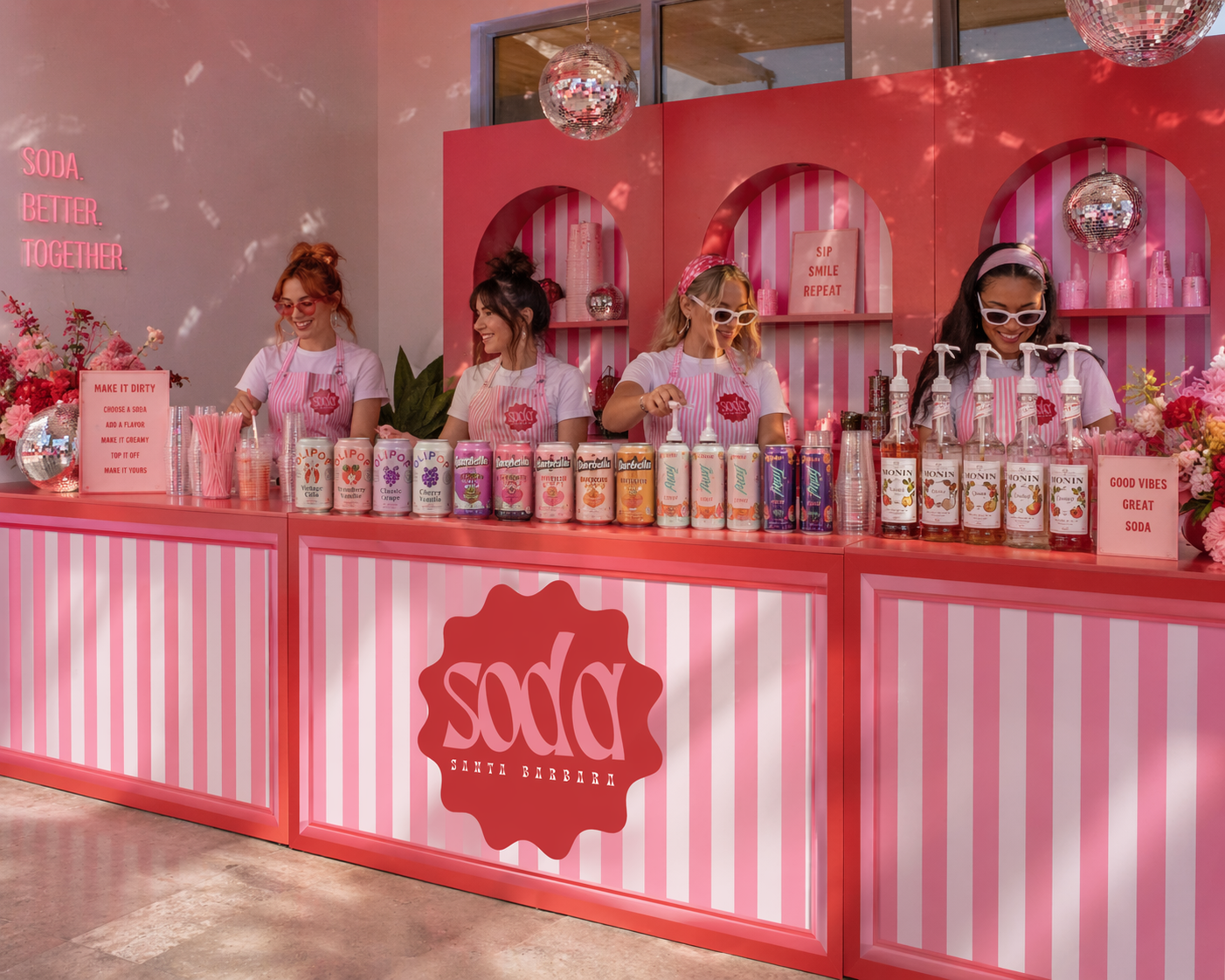 Red and white striped pop-up bar with bartenders serving dirty sodas